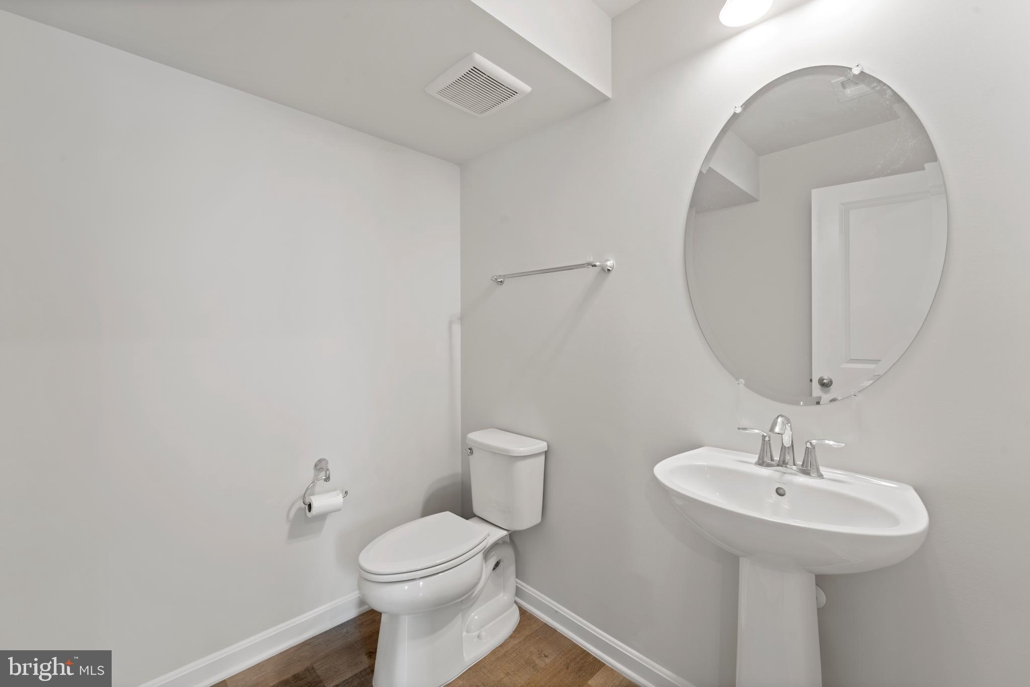 18216 Summit Pointe Drive Triangle, VA 22172 - Photo 23 of 25 a bathroom with a toilet sink and mirror