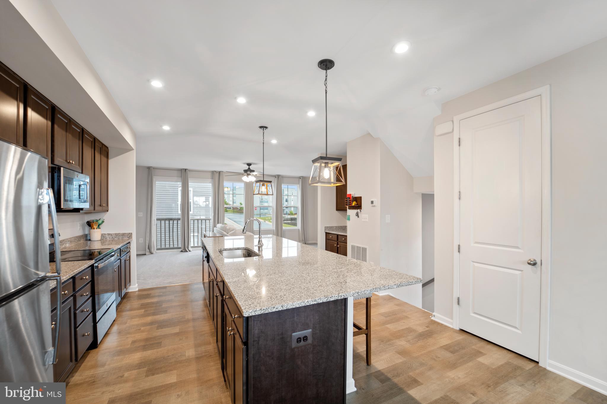 18216 Summit Pointe Drive Triangle, VA 22172 - Photo 6 of 25 a view of a kitchen with kitchen island a counter space a sink appliances and cabinets