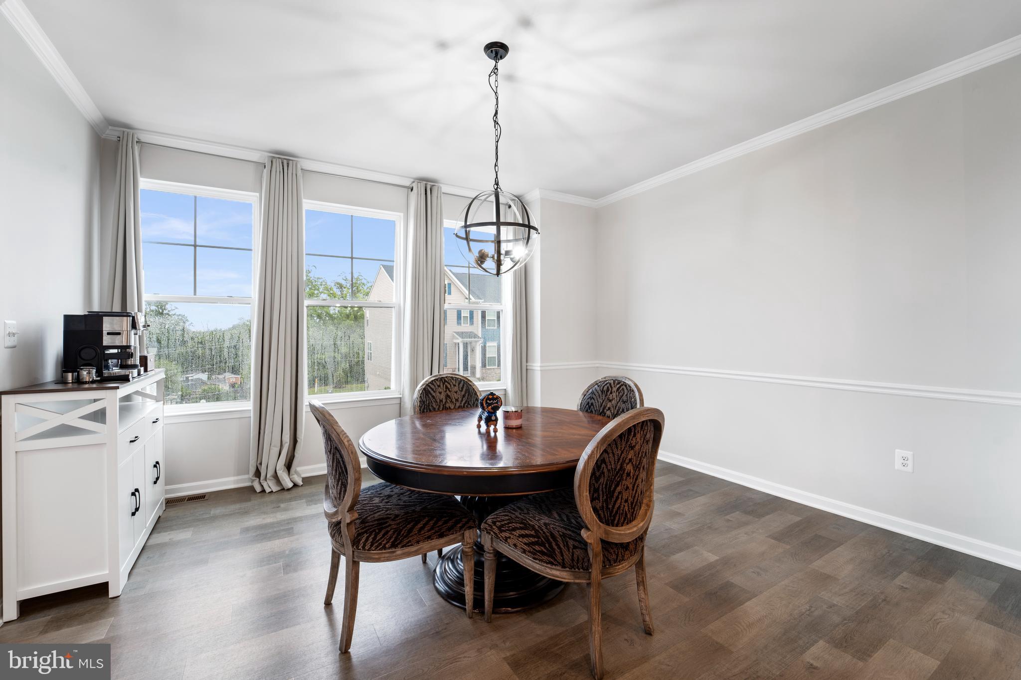 18216 Summit Pointe Drive Triangle, VA 22172 - Photo 7 of 25 a dining room with furniture a chandelier and wooden floor