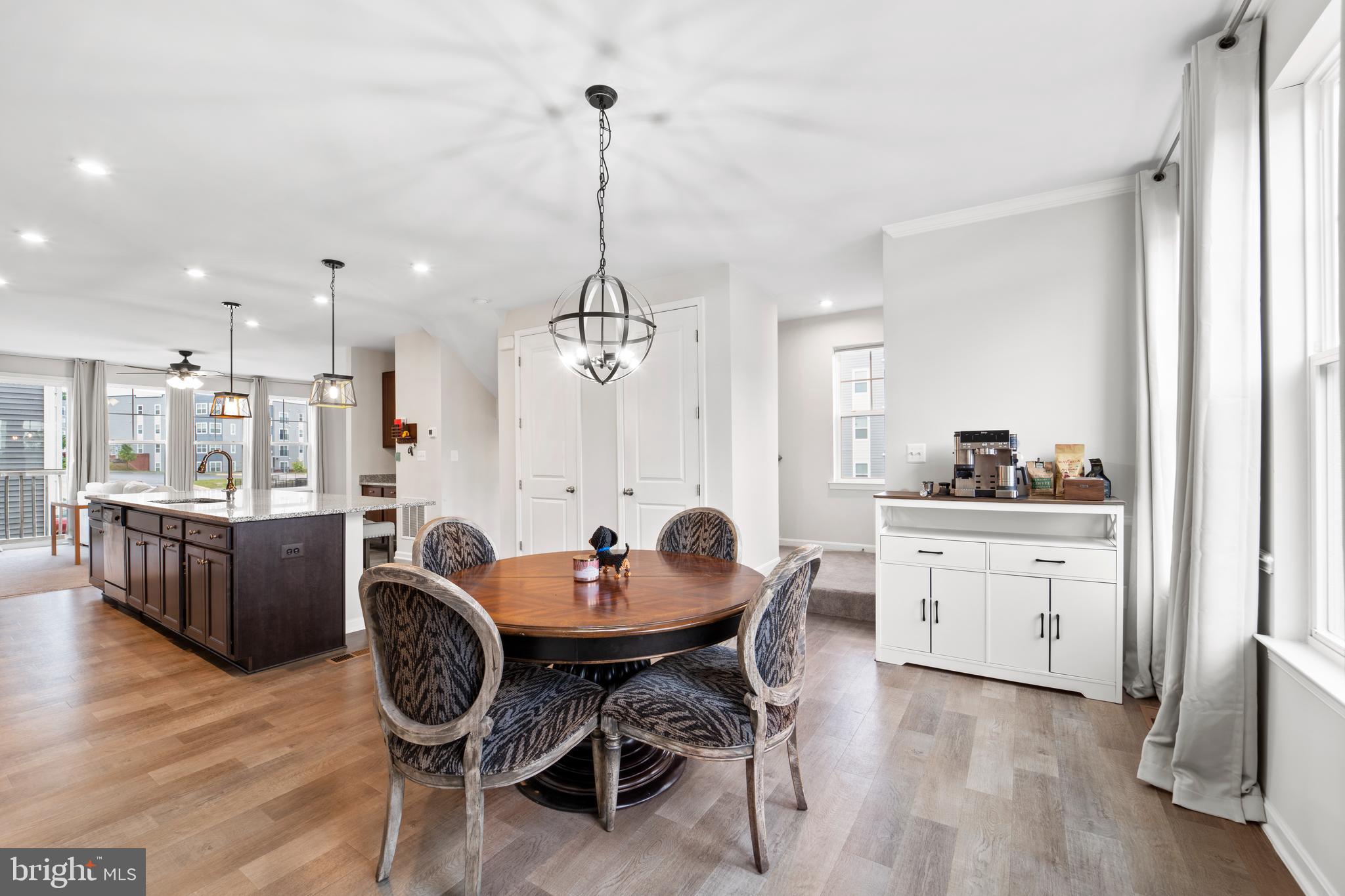 18216 Summit Pointe Drive Triangle, VA 22172 - Photo 8 of 25 a dining room with furniture a chandelier and wooden floor