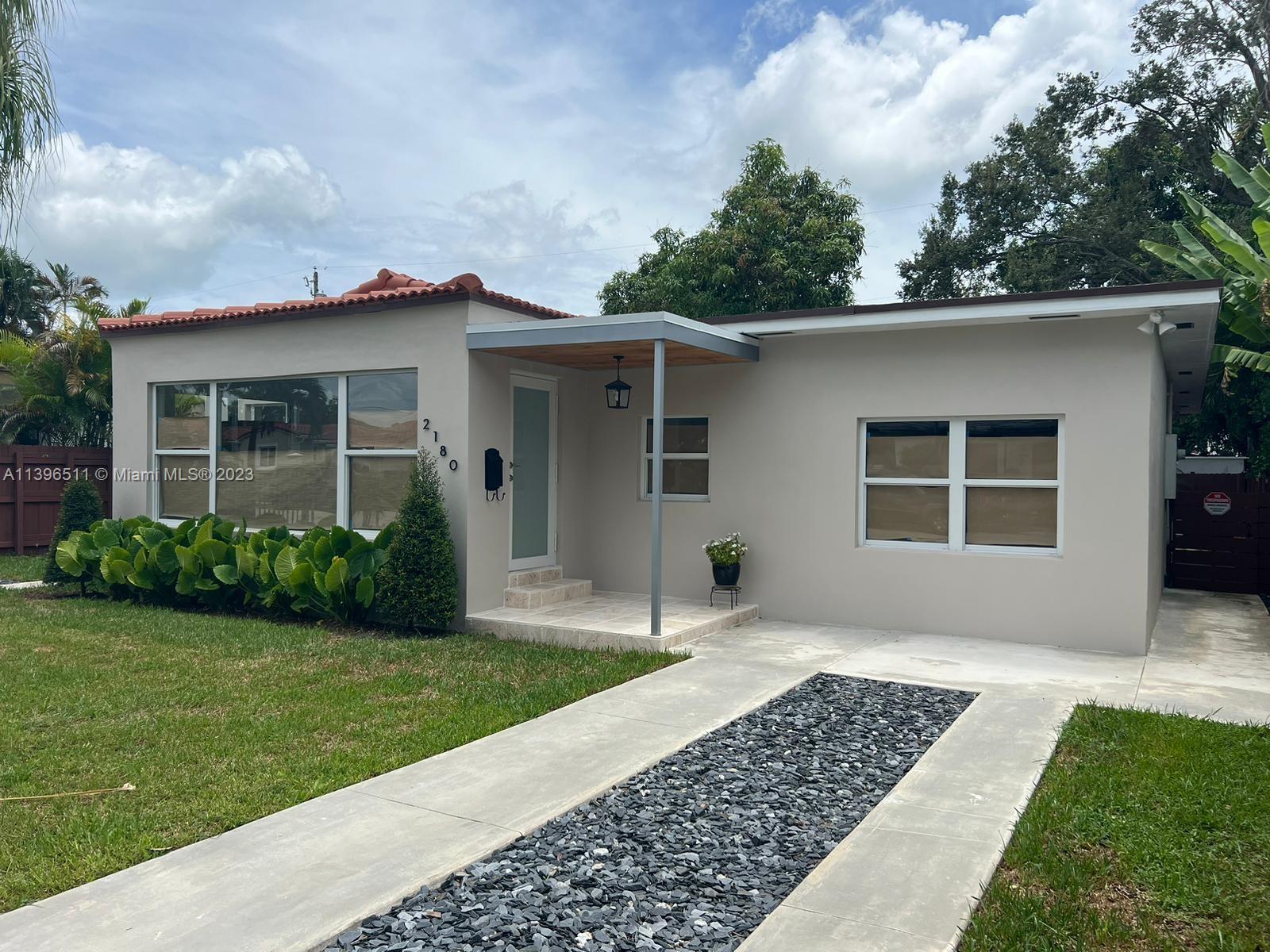 2180 Southwest 20th Street Miami, FL 33145 - Photo 19 of 31 a front view of a house with a yard