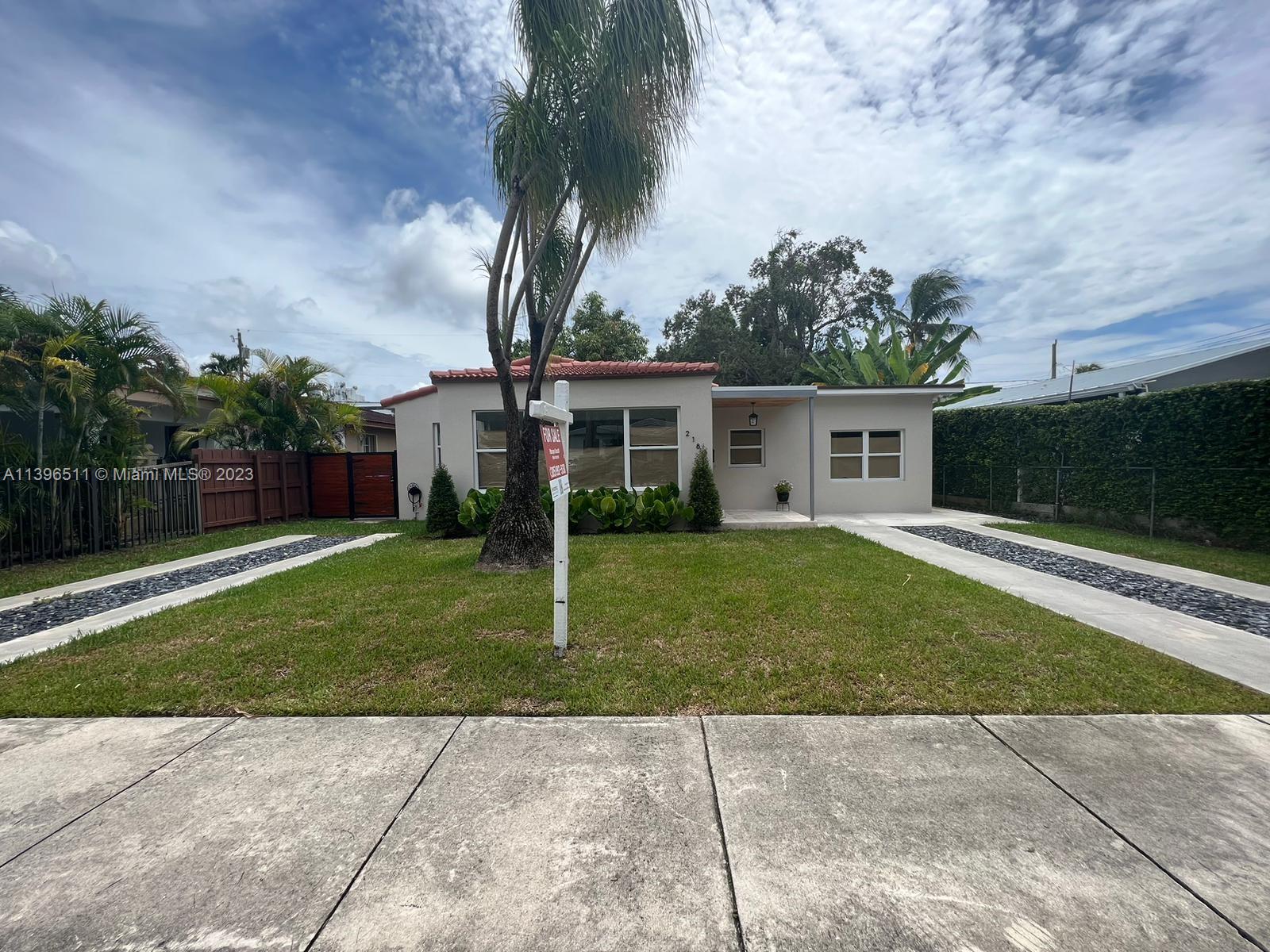 2180 Southwest 20th Street Miami, FL 33145 - Photo 20 of 31 a front view of a house with a garden