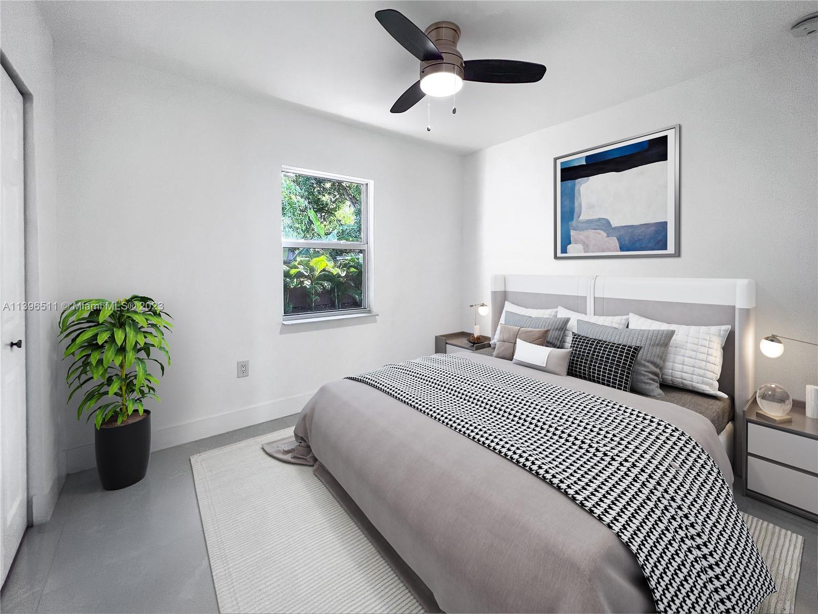 2180 Southwest 20th Street Miami, FL 33145 - Photo 24 of 31 a bedroom with a bed and a potted plant