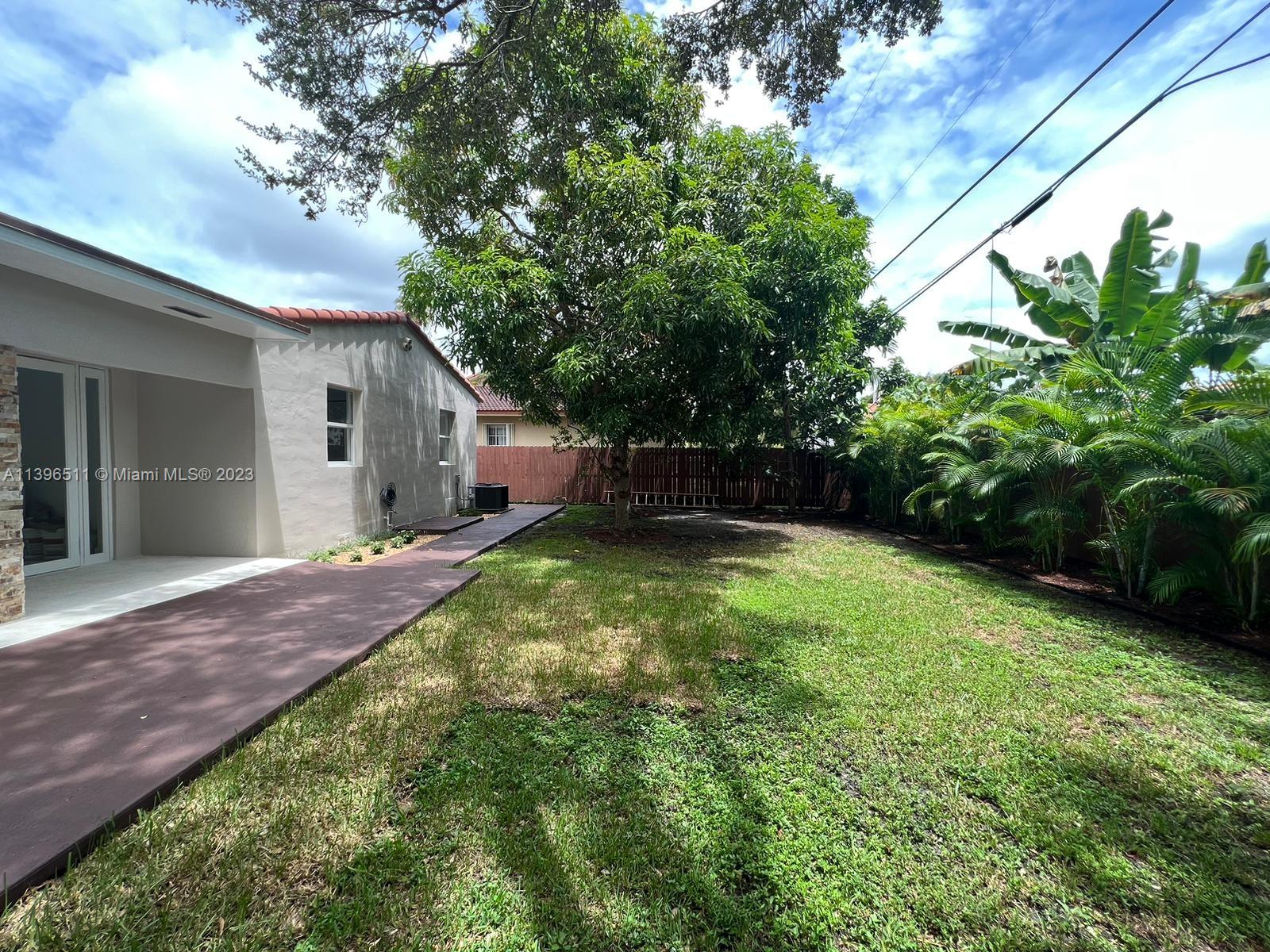 2180 Southwest 20th Street Miami, FL 33145 - Photo 26 of 31 a backyard of a house with lots of green space