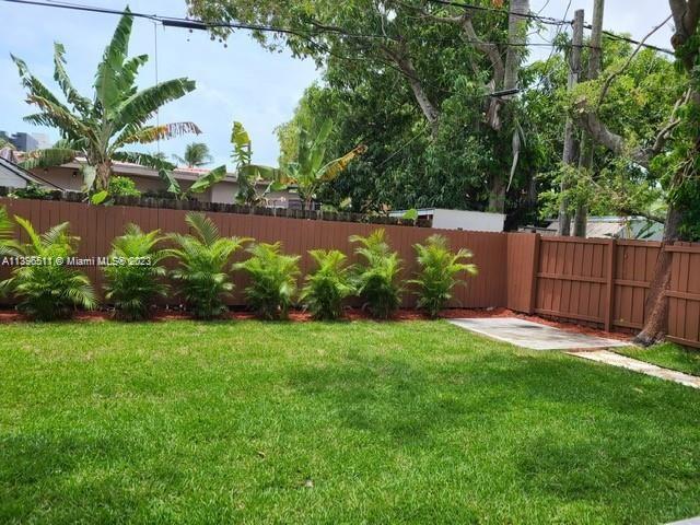 2180 Southwest 20th Street Miami, FL 33145 - Photo 29 of 31 a view of a garden with a bench in the background