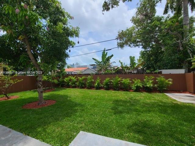 2180 Southwest 20th Street Miami, FL 33145 - Photo 30 of 31 a view of a backyard with plants and a bench