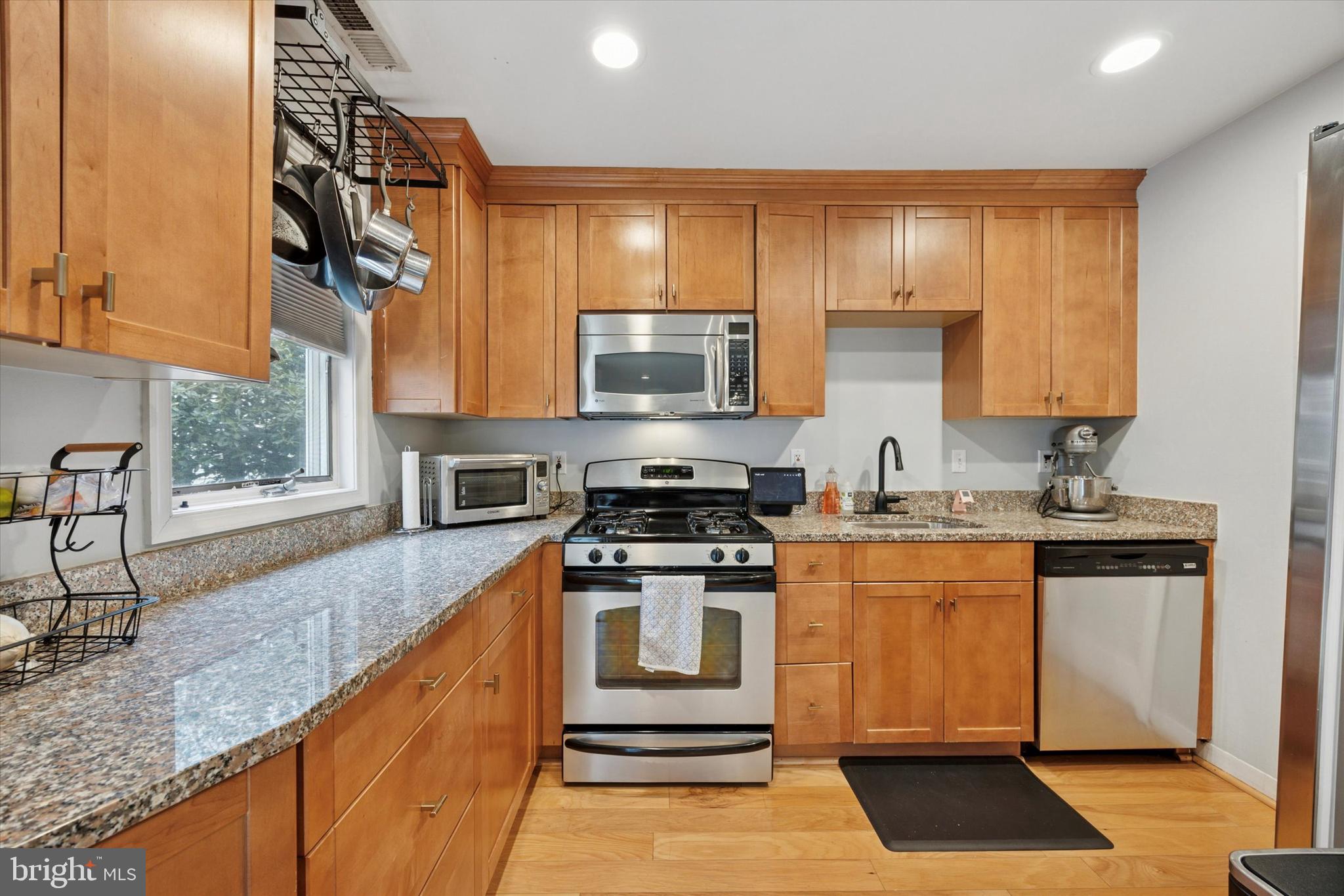 814 South Sheridan Street, Unit 2E Philadelphia, PA 19147 - Photo 2 of 24 a kitchen with stainless steel appliances granite countertop a stove a sink and a microwave