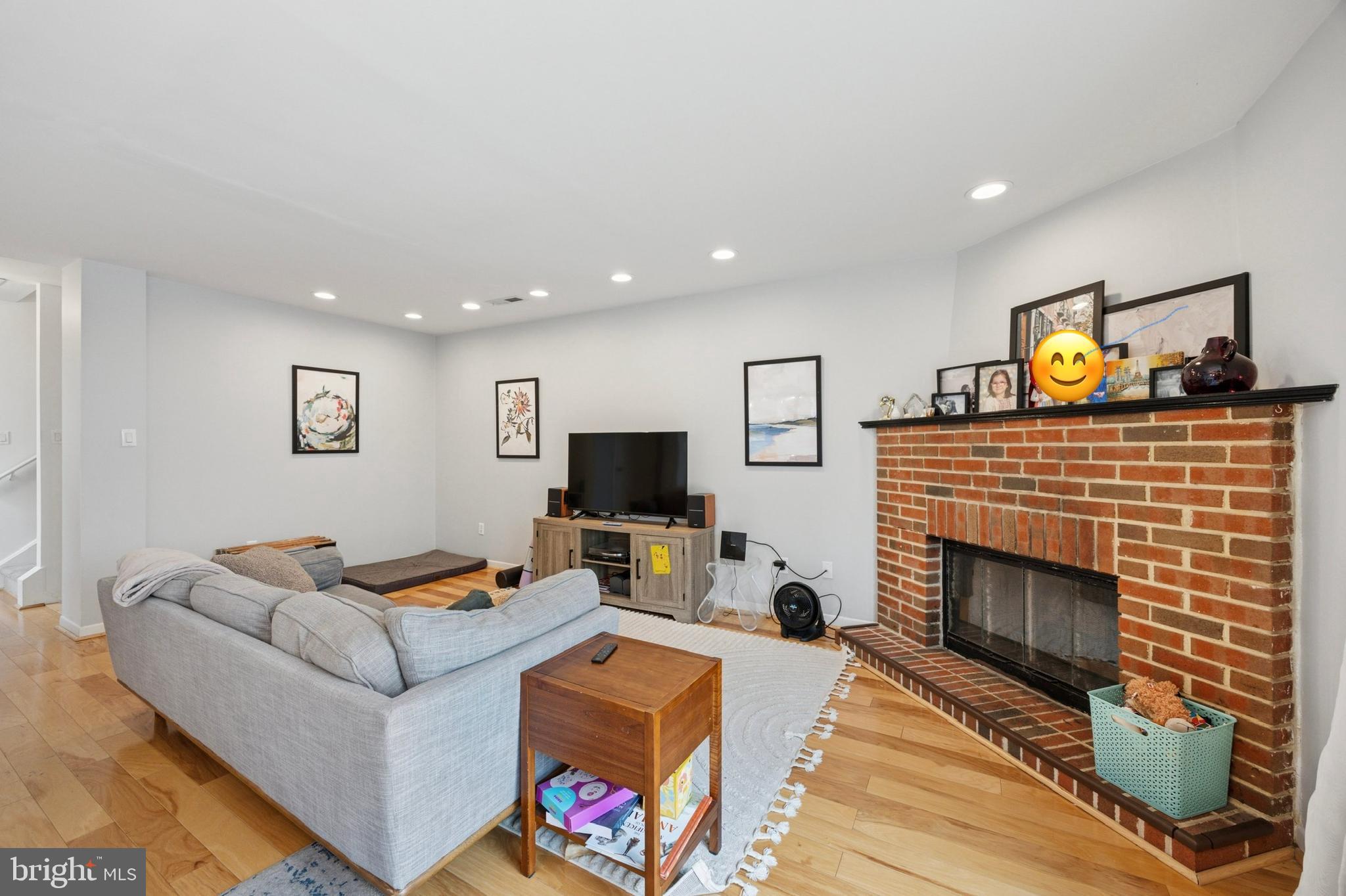 814 South Sheridan Street, Unit 2E Philadelphia, PA 19147 - Photo 3 of 24 a living room with furniture a flat screen tv and a fireplace