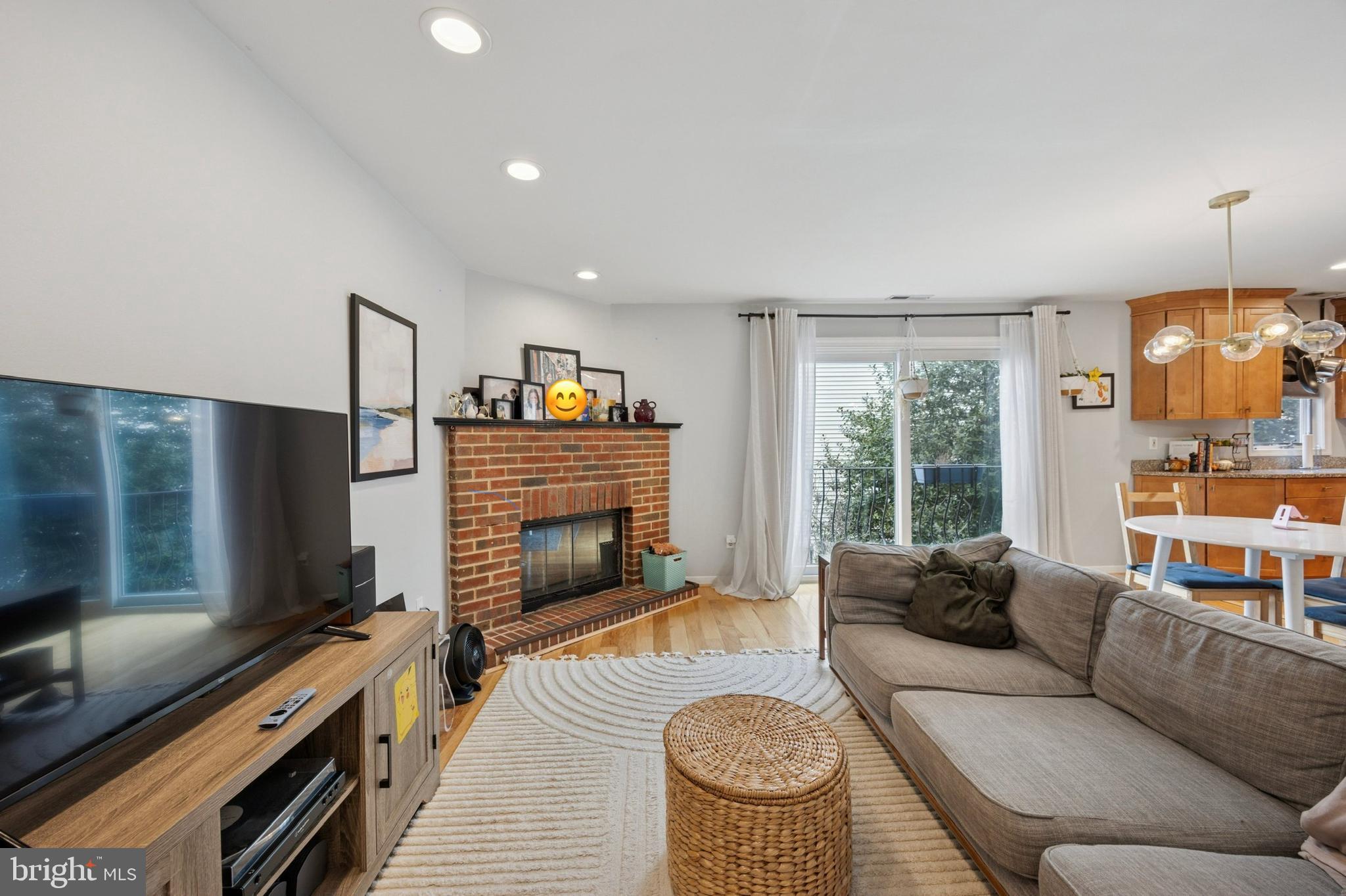 814 South Sheridan Street, Unit 2E Philadelphia, PA 19147 - Photo 5 of 24 a living room with furniture a flat screen tv and a fireplace