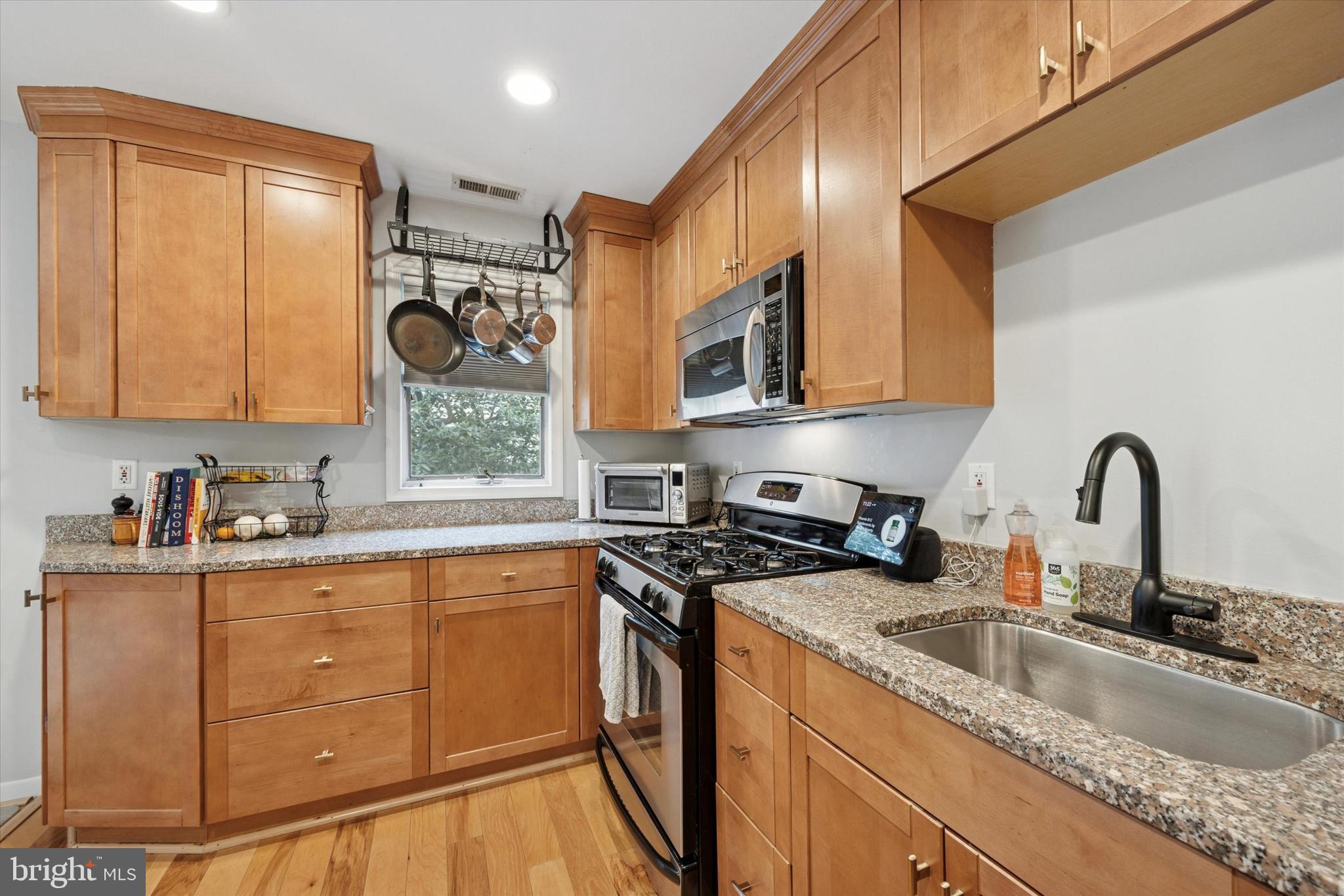 814 South Sheridan Street, Unit 2E Philadelphia, PA 19147 - Photo 6 of 24 a kitchen with stainless steel appliances granite countertop a sink stove and cabinets