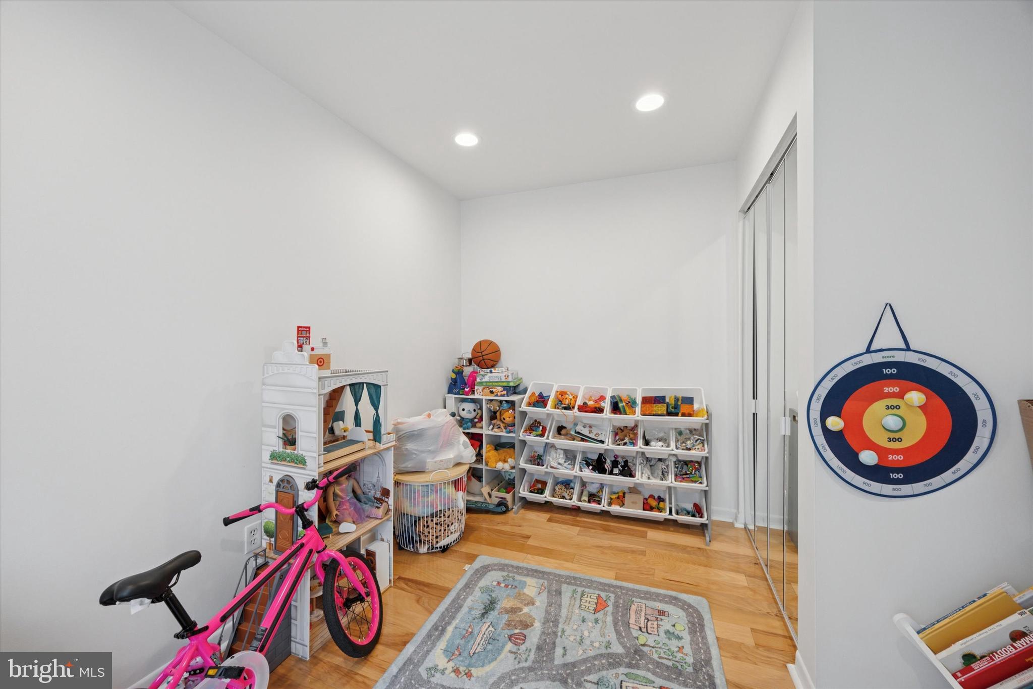 814 South Sheridan Street, Unit 2E Philadelphia, PA 19147 - Photo 10 of 24 a view of an empty room with toys and wooden floor