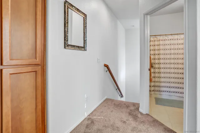 a view of a hallway with paintings on the wall