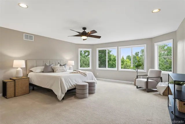 a spacious bedroom with a bed and a large window