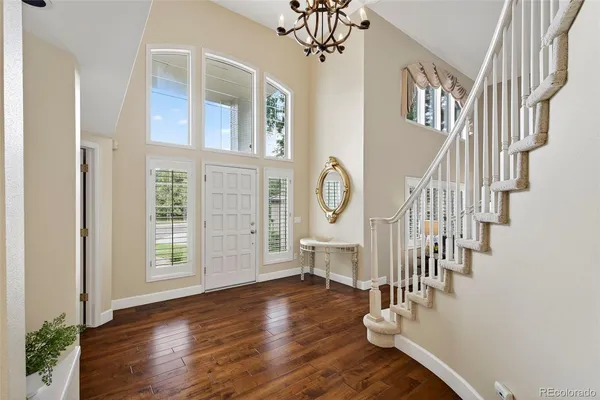 a view of entryway and hall with wooden floor