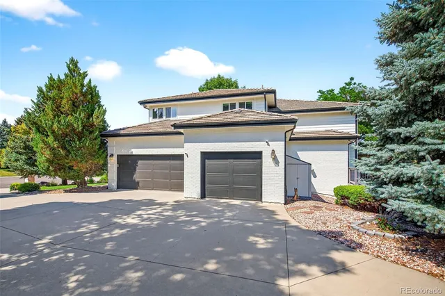 a view of a house with a yard and garage