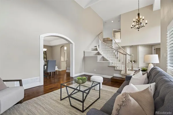 a living room with furniture and wooden floor