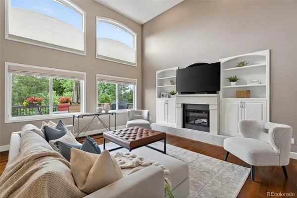 a living room with furniture a fireplace and a flat screen tv