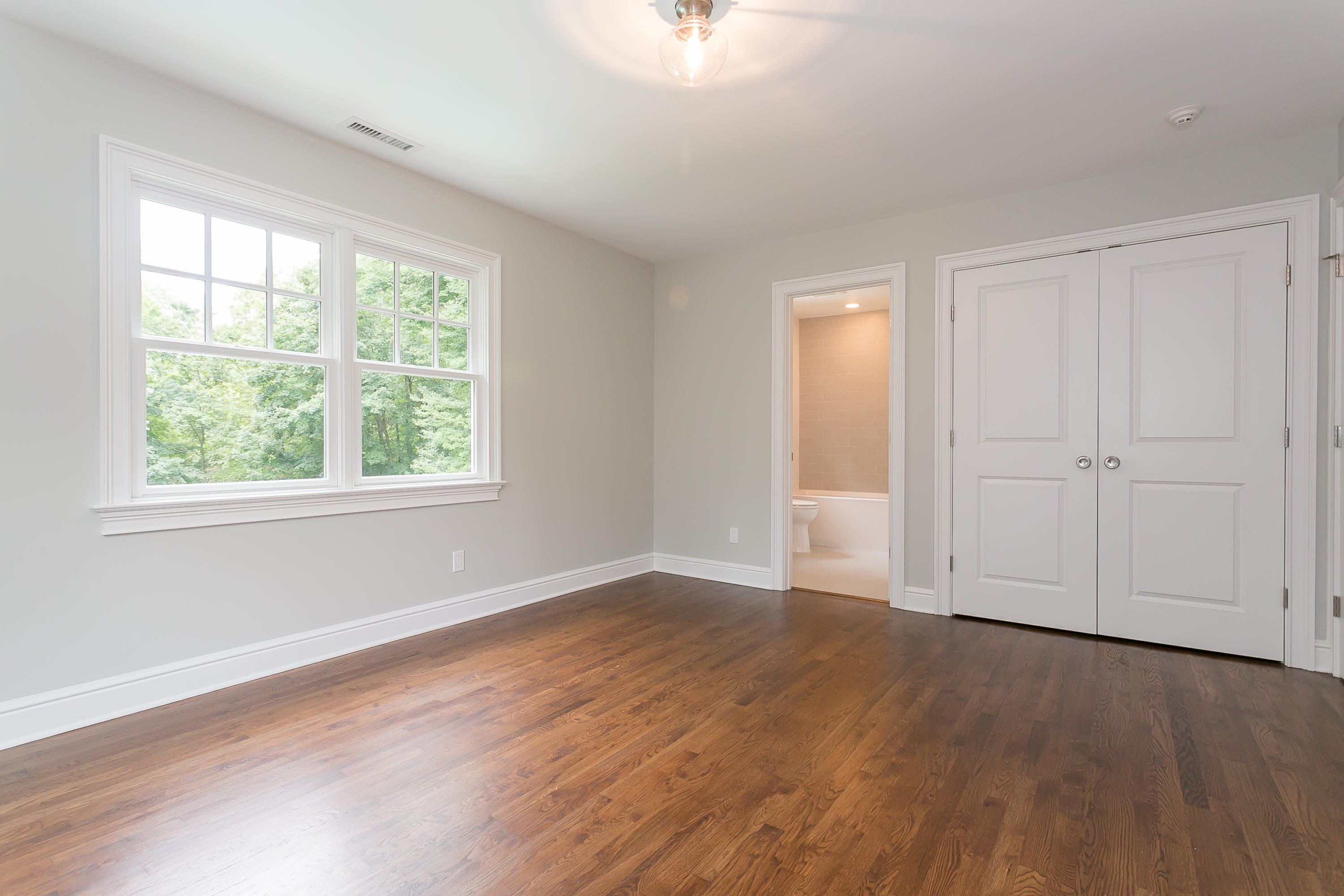26 Country Club Road Darien, CT 06820 - Photo 28 of 42 an empty room with wooden floor and windows