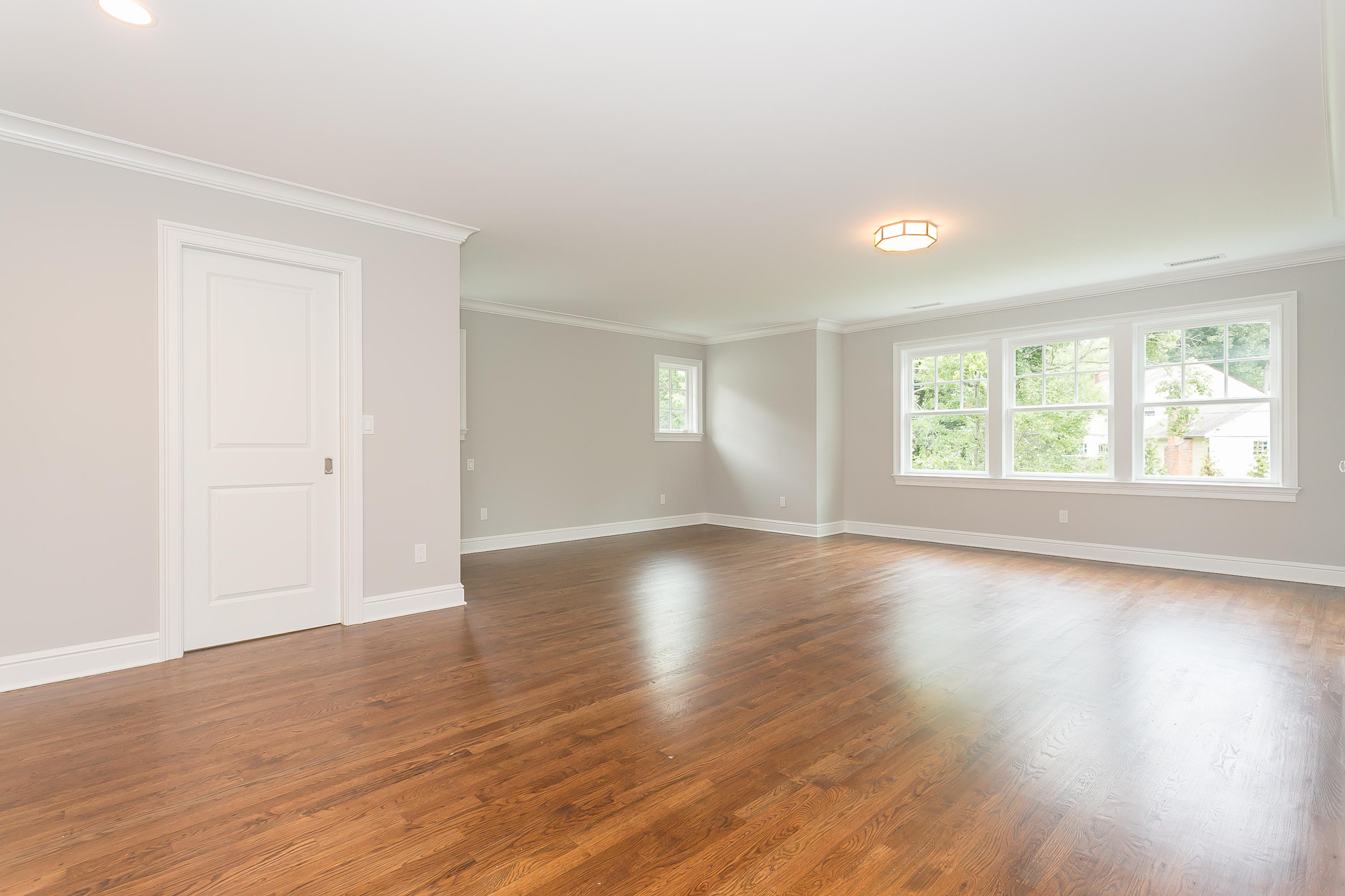 26 Country Club Road Darien, CT 06820 - Photo 38 of 42 an empty room with wooden floor and windows