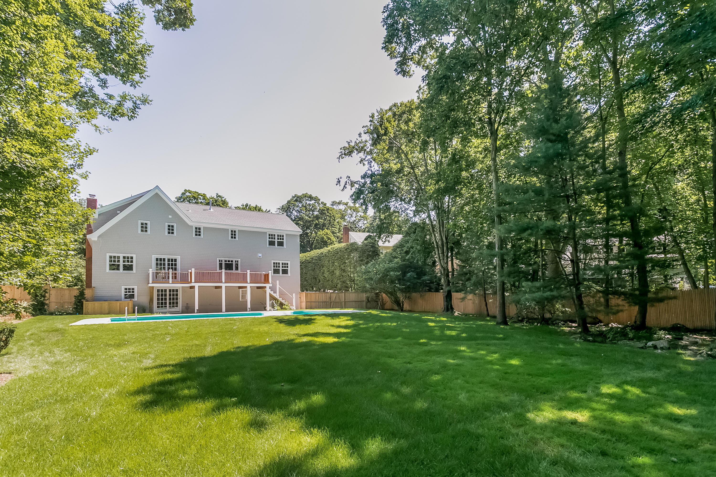 26 Country Club Road Darien, CT 06820 - Photo 8 of 42 a view of house with a big yard and large trees