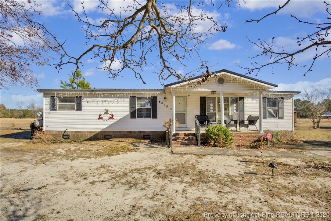 a front view of a house with sitting area
