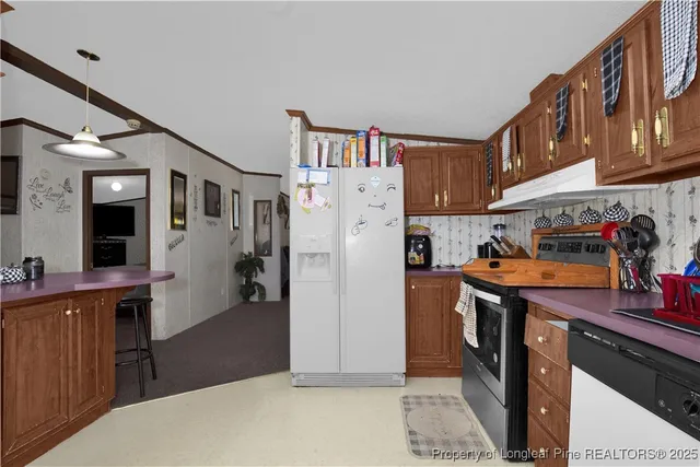 a kitchen with stainless steel appliances granite countertop a refrigerator and a stove