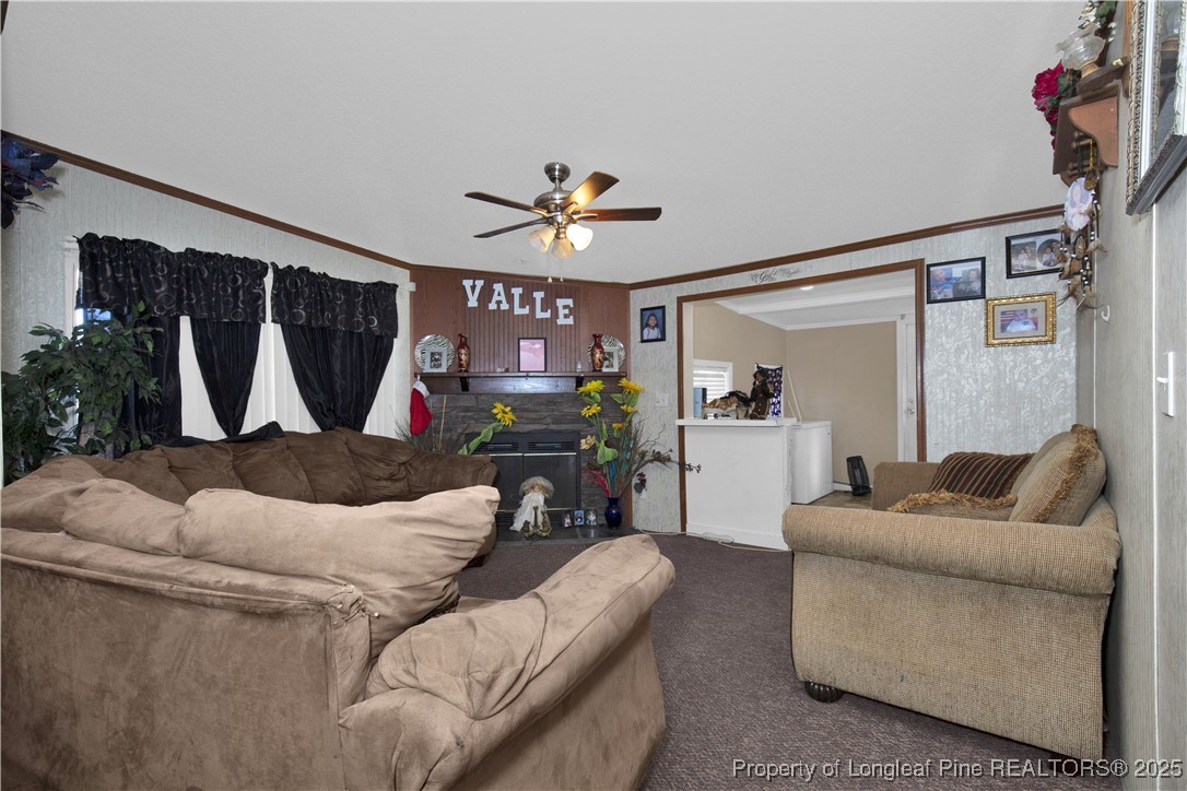 5065 Tobacco Road Orrum, NC 28369 - Photo 15 of 31 a living room with furniture and a flat screen tv