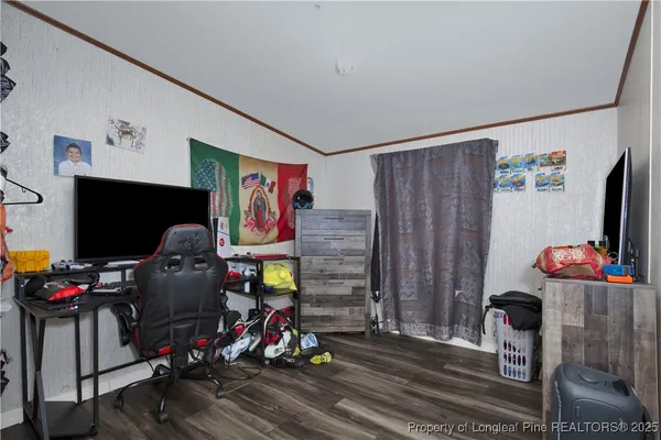 a living room with furniture a flat screen tv and gym equipment