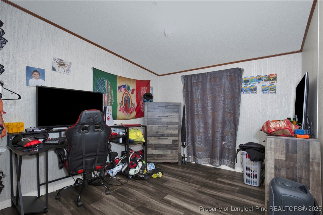 5065 Tobacco Road Orrum, NC 28369 - Photo 21 of 31 a living room with furniture a flat screen tv and gym equipment