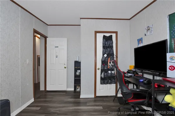 a room with wooden floor and gym equipment