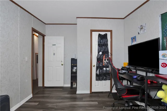 a room with wooden floor and gym equipment