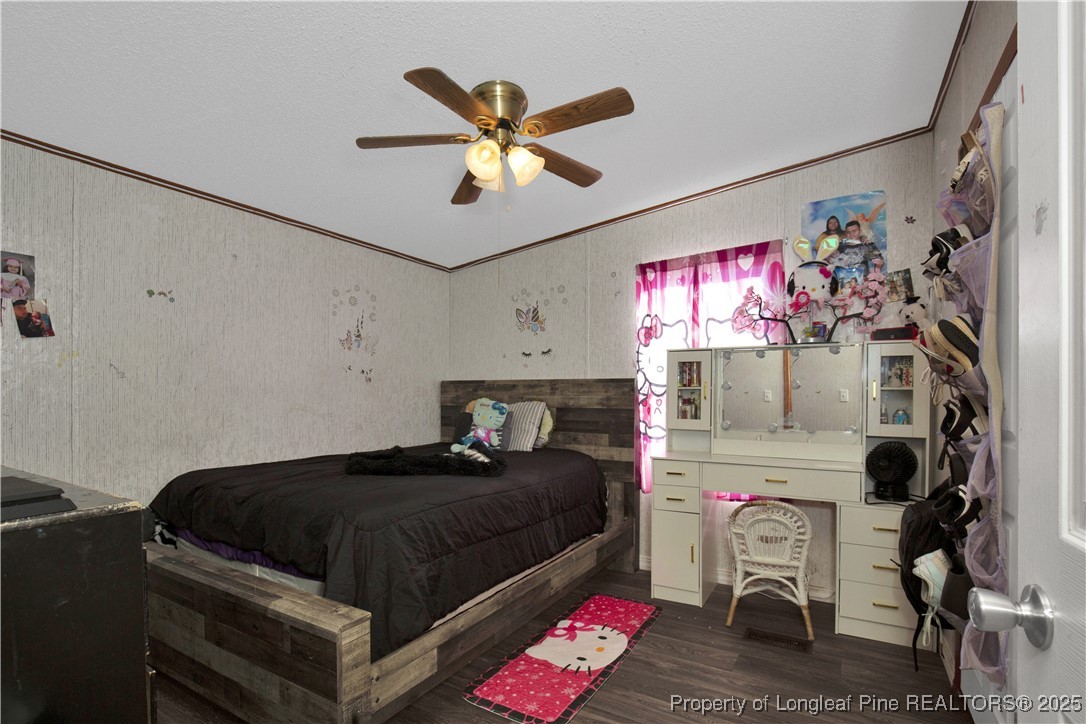 5065 Tobacco Road Orrum, NC 28369 - Photo 23 of 31 a bedroom with furniture and a chandelier