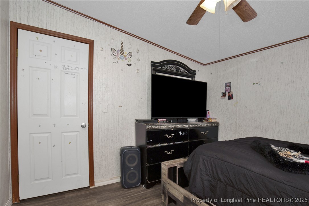 5065 Tobacco Road Orrum, NC 28369 - Photo 24 of 31 a bedroom with a bed and a flat tv screen on wall