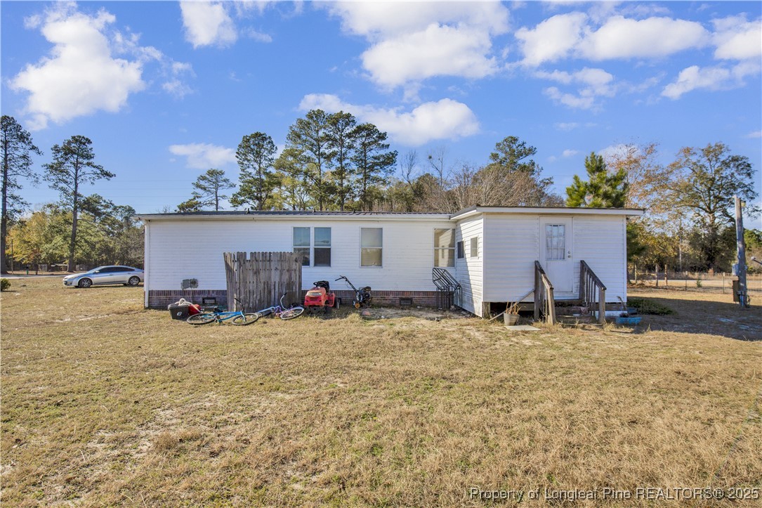 5065 Tobacco Road Orrum, NC 28369 - Photo 26 of 31 a view of a house with backyard and trees