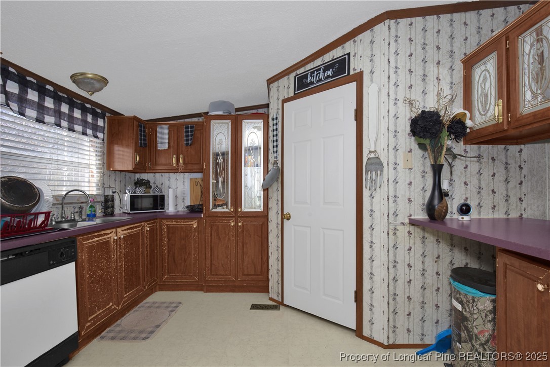 5065 Tobacco Road Orrum, NC 28369 - Photo 10 of 31 a kitchen with stainless steel appliances granite countertop a refrigerator and a stove top oven