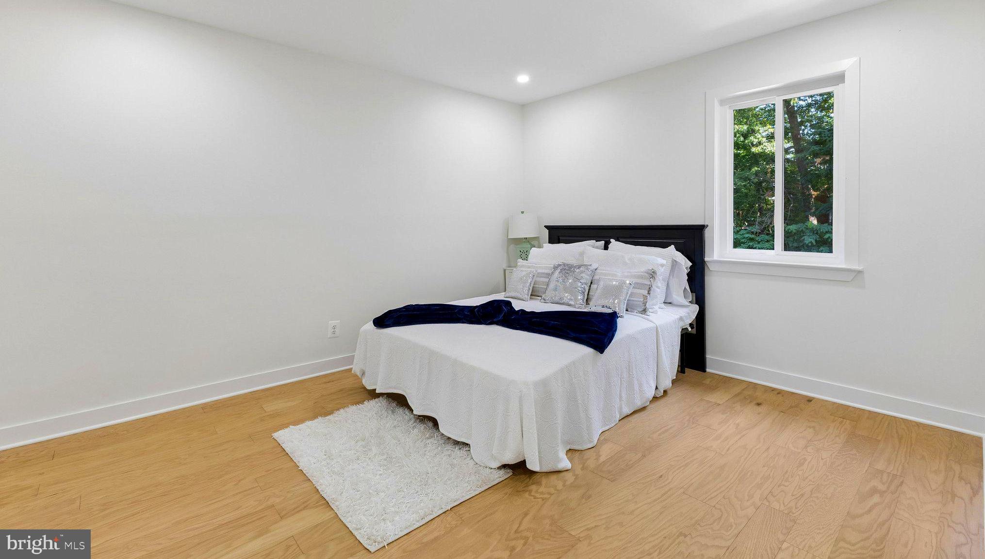 11841 Shire Court, Unit 31D Reston, VA 20191 - Photo 22 of 24 a spacious bedroom with a bed and a window