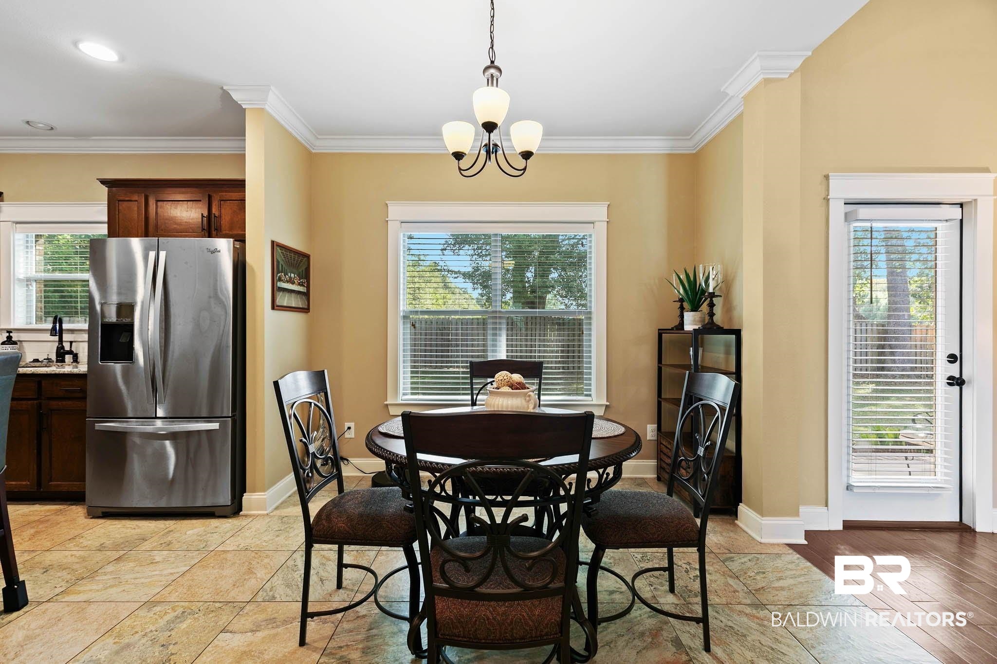 19740 Bunker Loop Fairhope, AL 36532 - Photo 10 of 33 Dining space featuring a chandelier and crown molding