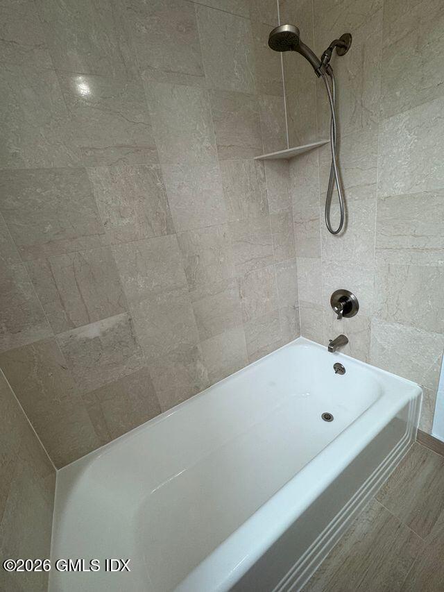 25 West Elm Street, Unit 40 Greenwich, CT 06830 - Photo 20 of 28 a bathroom with a white bath tub and a shower