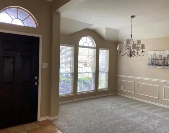 a view of empty room with window and ceiling fan