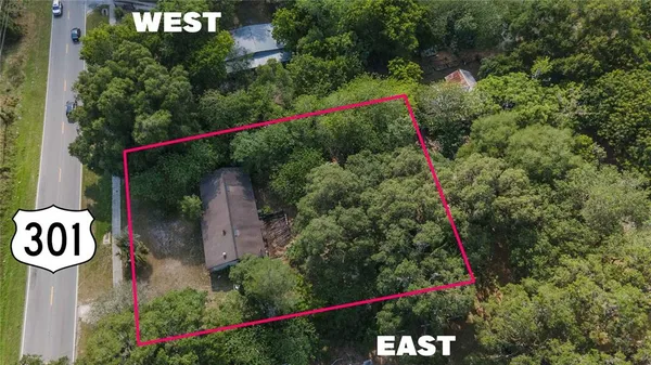 a view of a sign in front of flowers