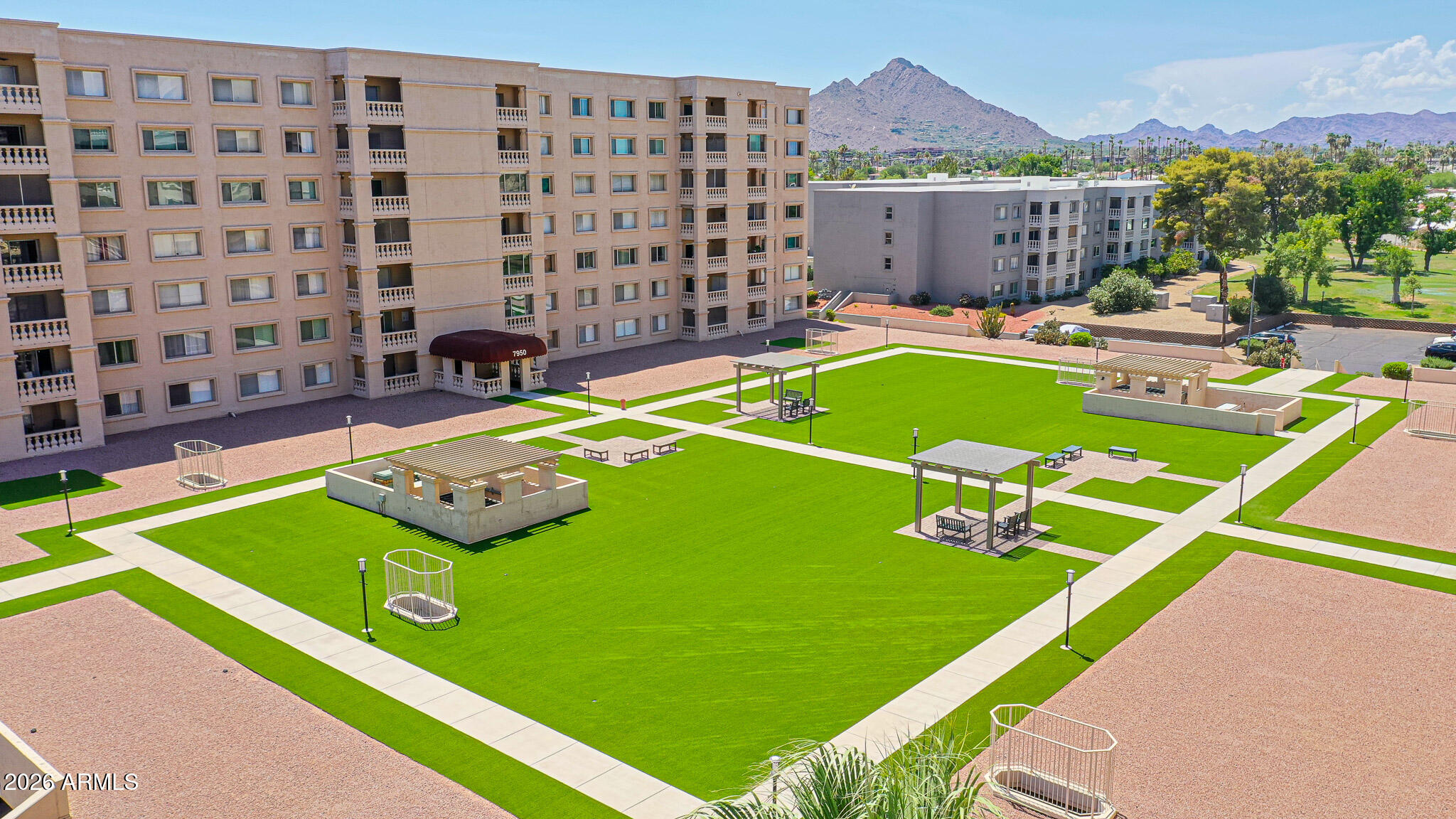 7920 East Camelback Road, Unit 111 Scottsdale, AZ 85251 - Photo 28 of 32 a view of a pool with lawn chairs