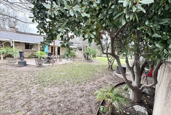 a view of outdoor space with garden and trees