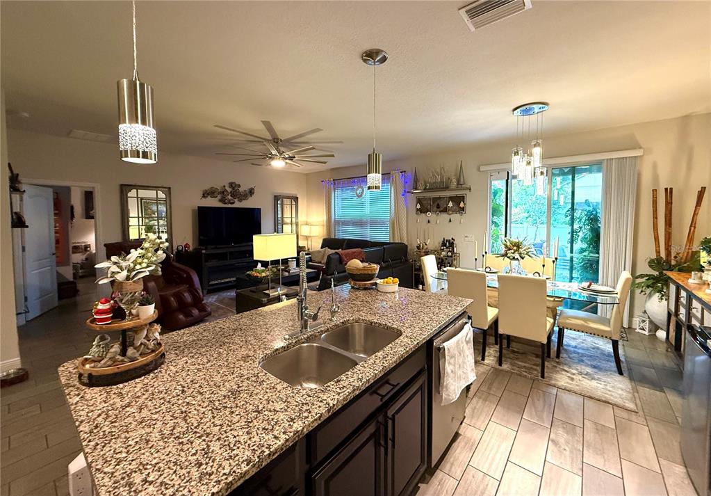 11104 Spring Point Circle Riverview, FL 33579 - Photo 19 of 52 a kitchen with sink stove and living room view