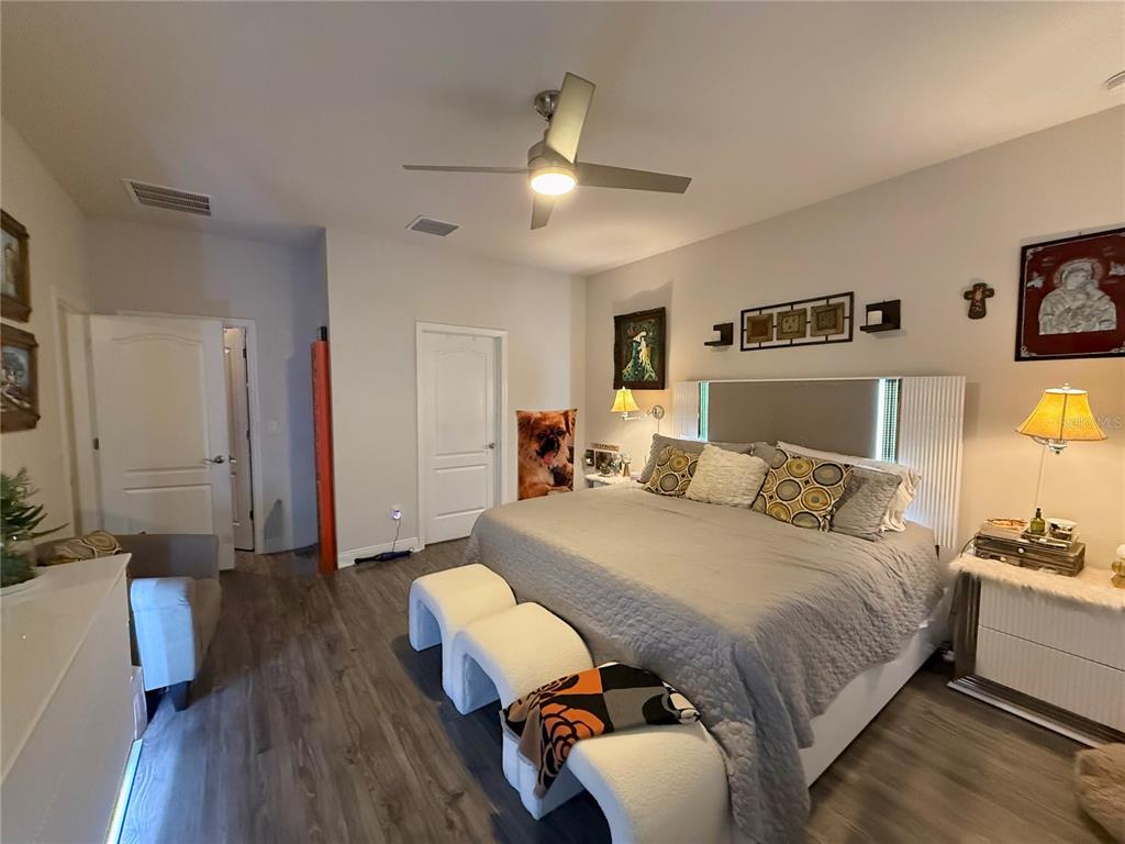 11104 Spring Point Circle Riverview, FL 33579 - Photo 23 of 52 a bedroom with a bed and wooden floor