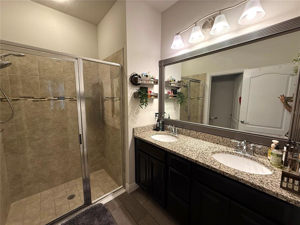 11104 Spring Point Circle Riverview, FL 33579 - Photo 24 of 52 a bathroom with a granite countertop sink mirror and double