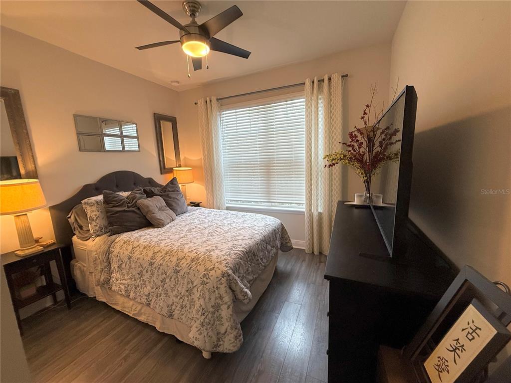 11104 Spring Point Circle Riverview, FL 33579 - Photo 6 of 52 a bedroom with a bed and a chandelier