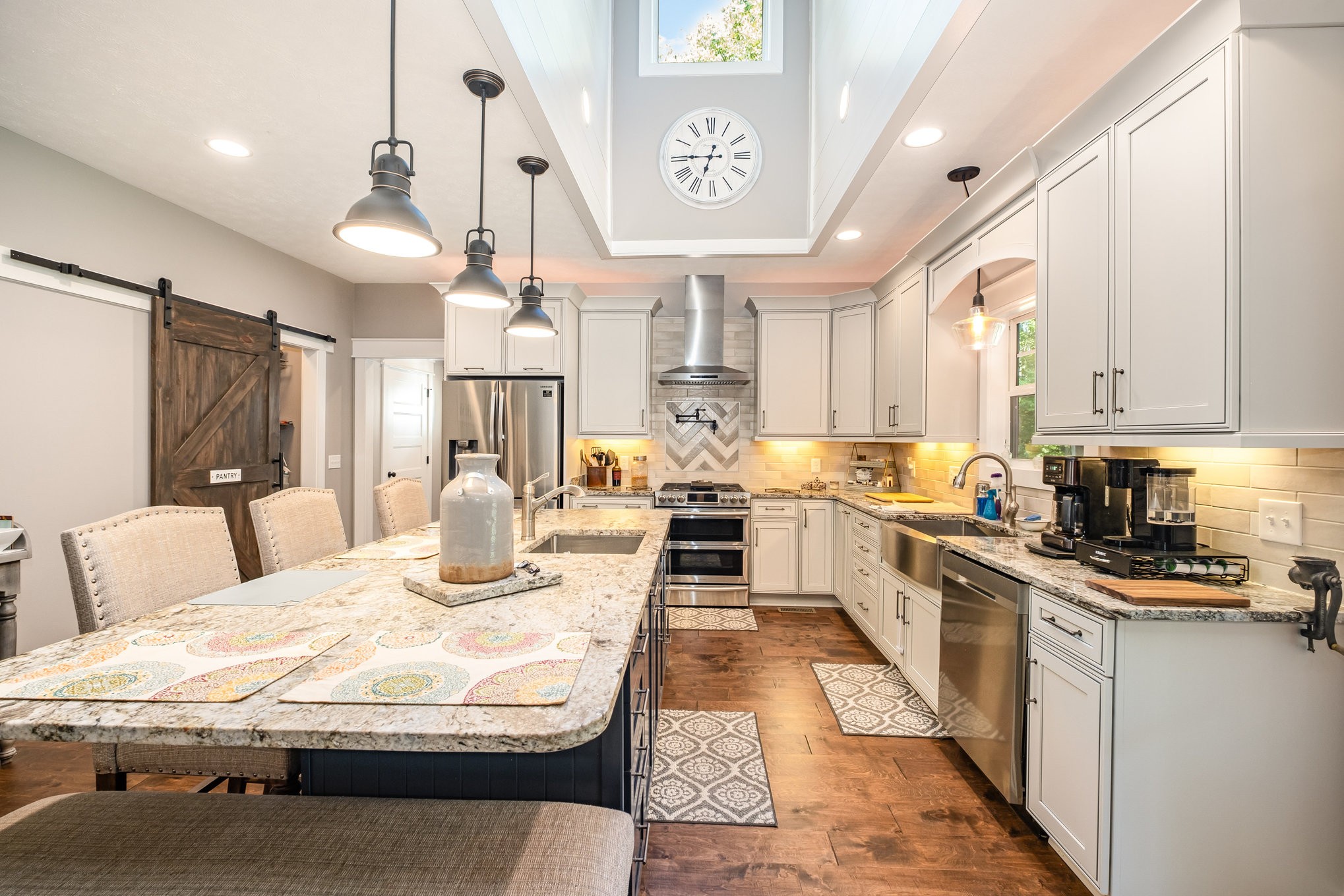 8129 Hollow Springs Road Bradyville, TN 37026 - Photo 29 of 42 a large white kitchen with lots of counter space wooden floor and stainless steel appliances