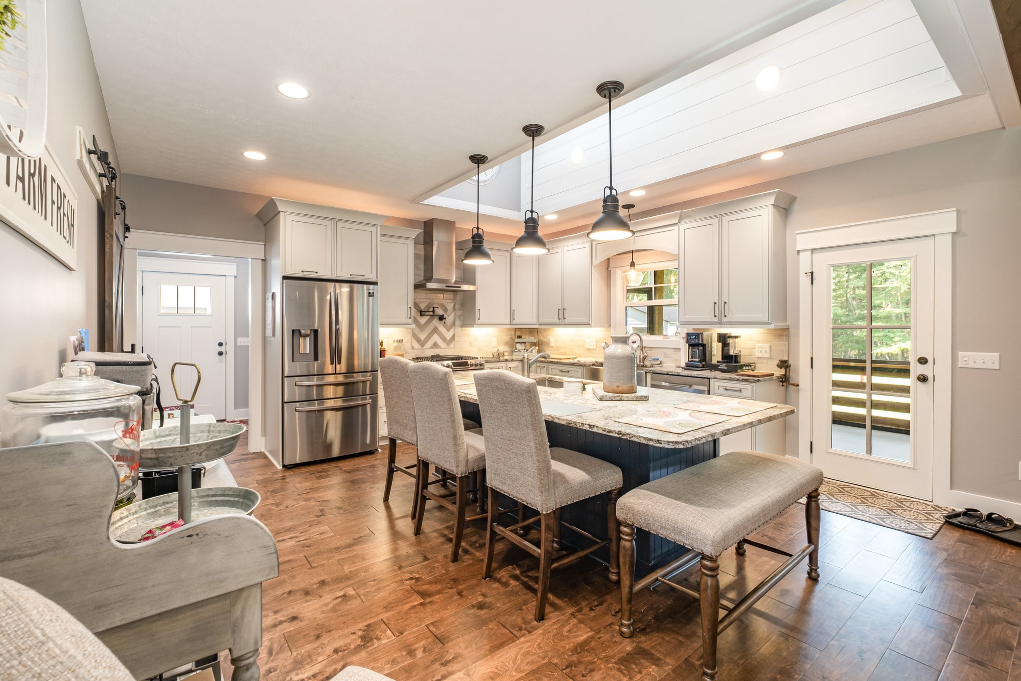 8129 Hollow Springs Road Bradyville, TN 37026 - Photo 30 of 42 a dining room with stainless steel appliances kitchen island granite countertop a dining table chairs and view living room
