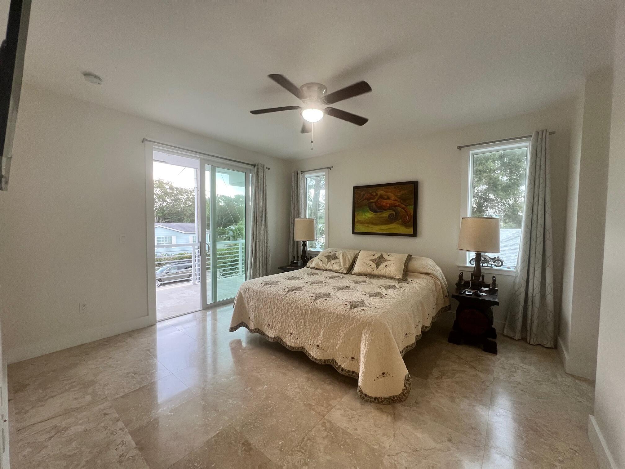 4 Pelican Road Key Largo, FL 33037 - Photo 11 of 15 a spacious bedroom with a bed and large window