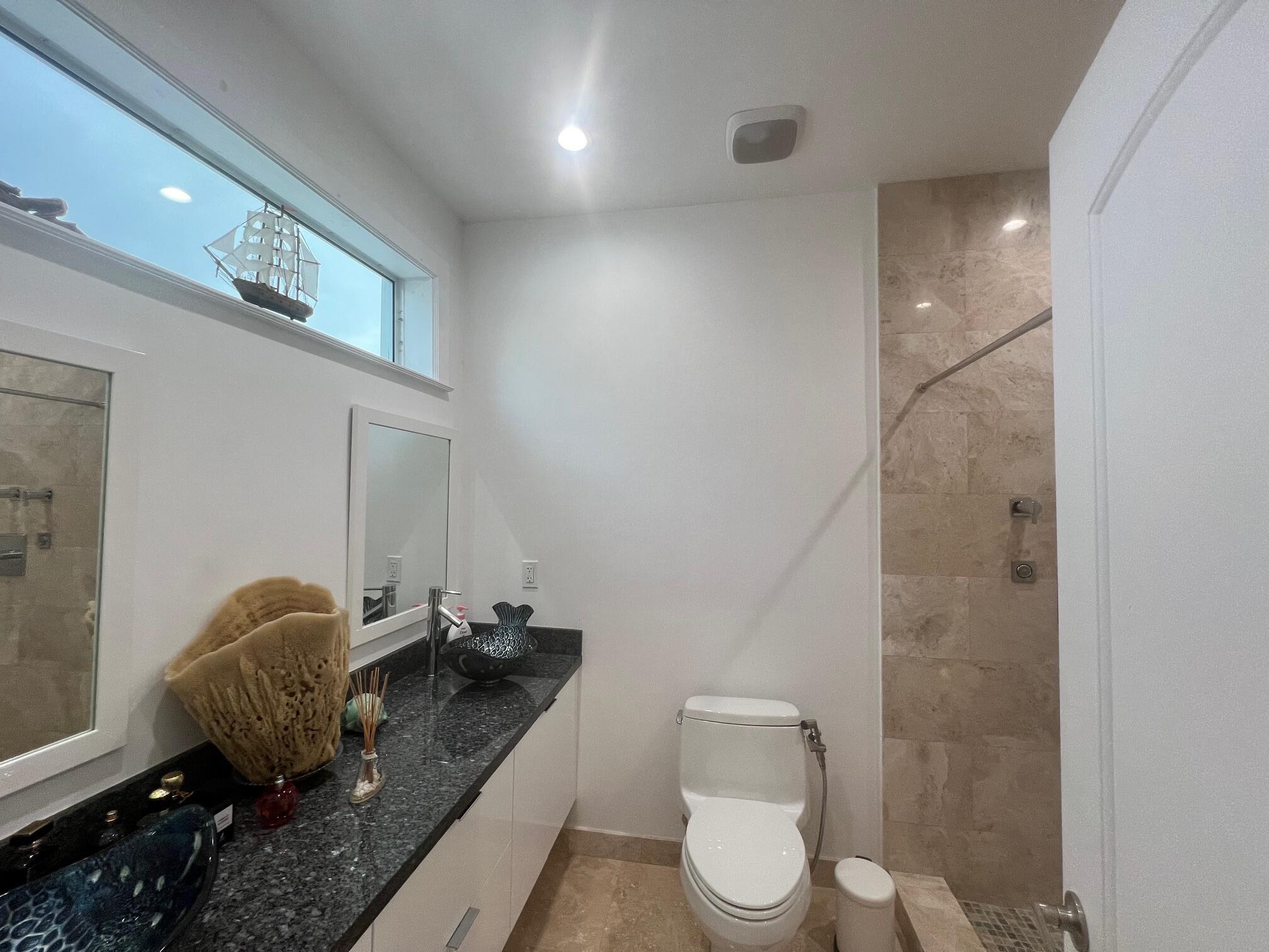 4 Pelican Road Key Largo, FL 33037 - Photo 13 of 15 a bathroom with a granite countertop sink mirror vanity and toilet